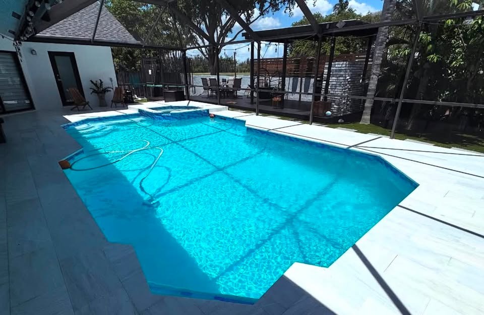 Screened lanai pool remodel with turquoise finish and raised spa